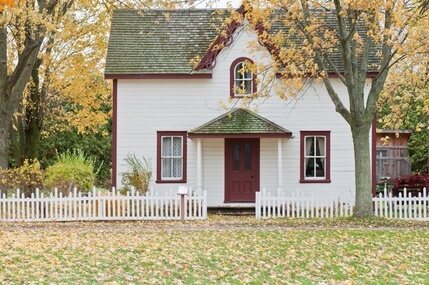 White house with white picket fence